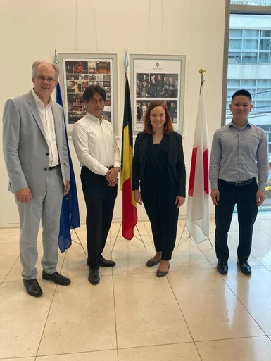 Picture showing Philippe Chevalier, Sophie Marquet, and JEPX representative in front of their national flags in an office